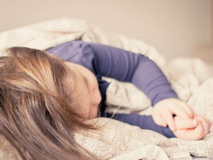Child sleeping with weighted blanket
