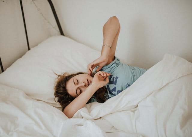 woman covered with duvet